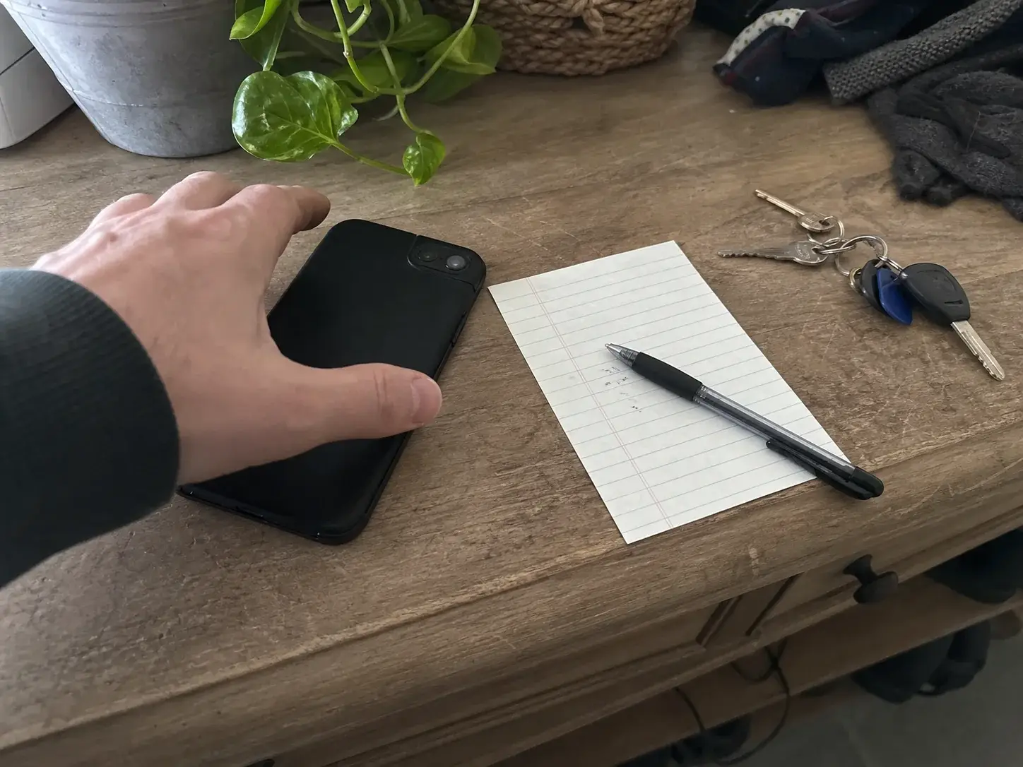 Customer phone and appointment note beside front door keys